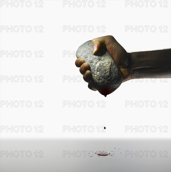 Hand holding a stone