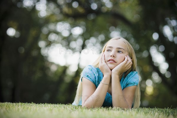 Young girl lying on grass