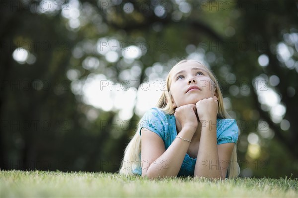 Young girl lying on grass