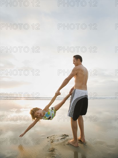 Man swinging girl