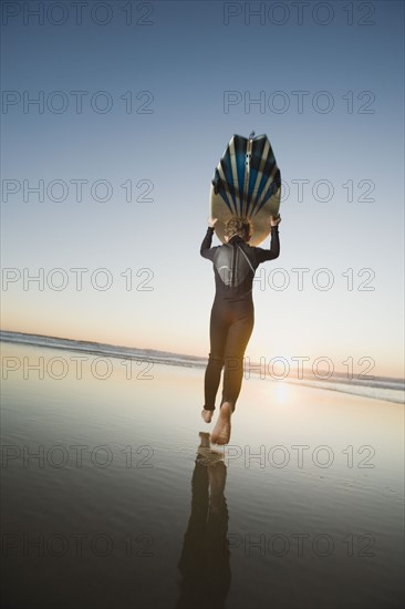 Child holding surfboard