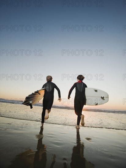 Kids on beach with surfboards