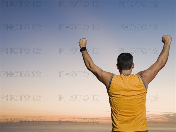 Man raising arms
