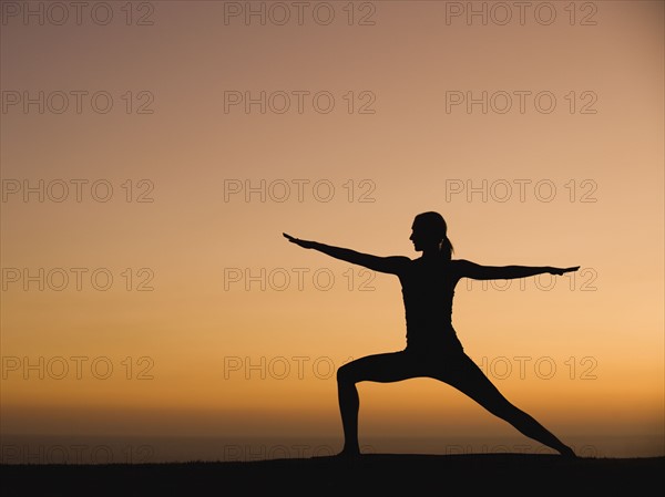 Silhouette of woman doing yoga