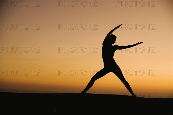 Silhouette of woman doing yoga