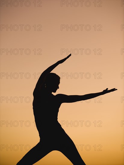 Silhouette of woman doing yoga