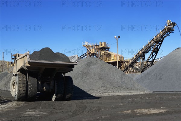 Truck and gravel piles