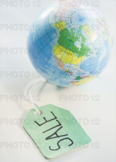 Sale tag beside globe