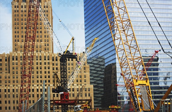 Cranes in front of buildings