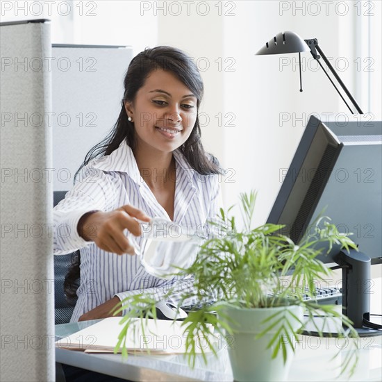 Woman watering plant