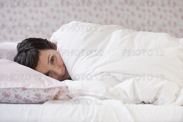 Woman lying in bed.