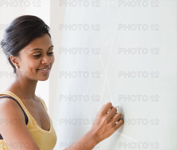 Woman writing on chalkboard