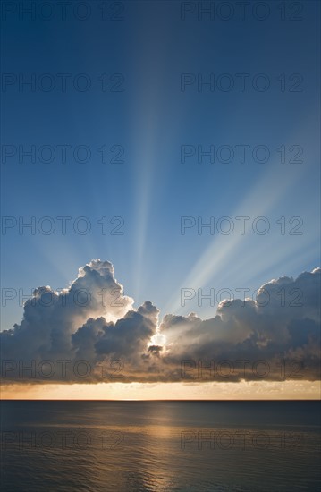 Sunset behind clouds.