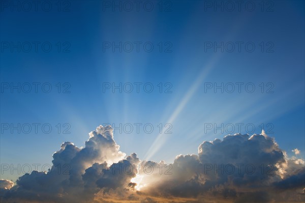 Sunset behind clouds.