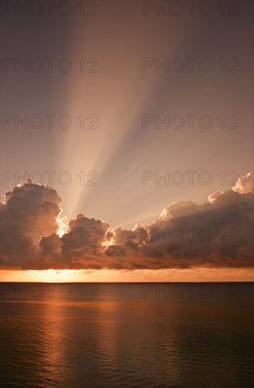 Sunset behind clouds.