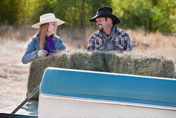 Lifting bales of hay.