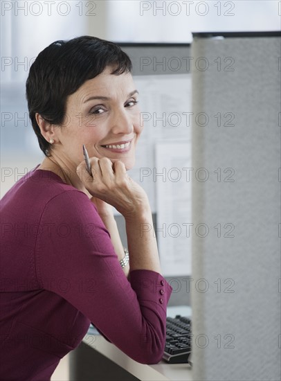 Businesswoman sitting at desk.