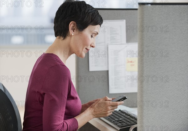 Businesswoman sitting at desk.