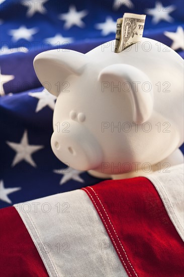 Piggybank on top of American flag.