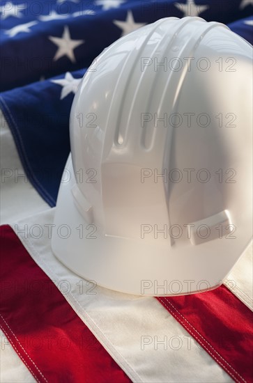 Hard hat on top of American flag.