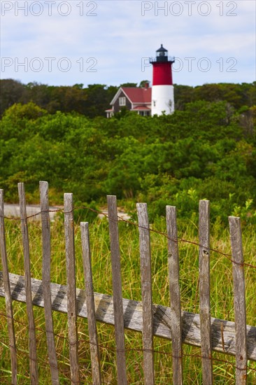 Fence in front of lighthouse.