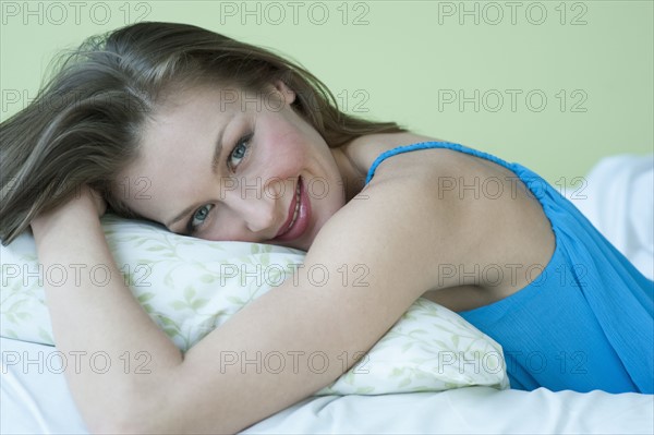 Woman resting in bed.