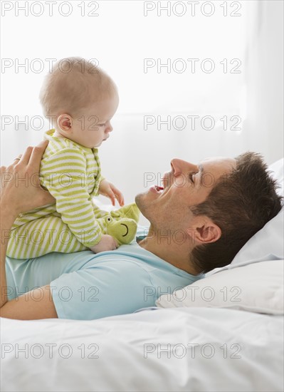 Father and baby playing.