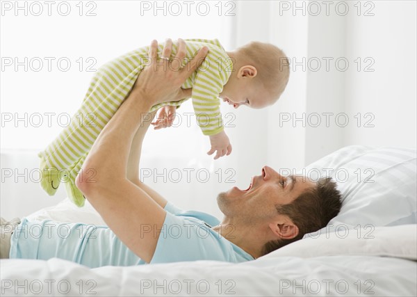 Father and baby playing.