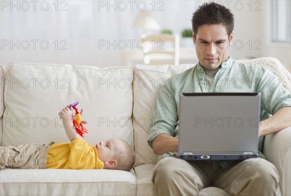 Father and son on couch.