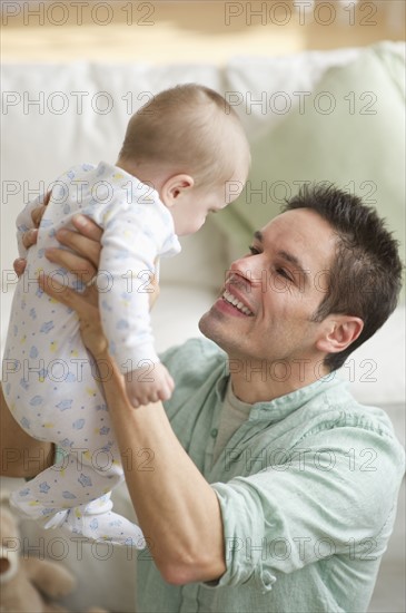 Father holding baby.