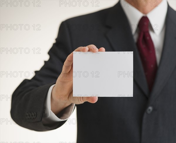 Businessman holding blank paper.