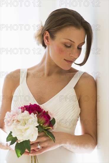 Bride holding bouquet of flowers.