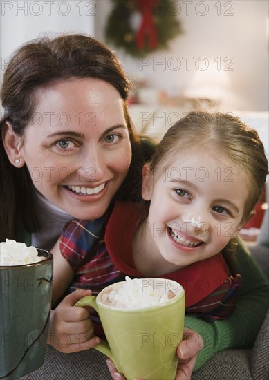 Mother and daughter drinking hot chocolate. Photographer: Jamie Grill