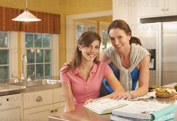 Mother and daughter in kitchen. Photographer: mark edward atkinson