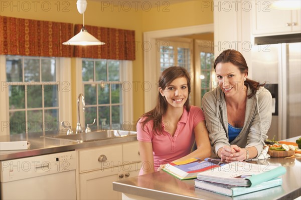 Mother and daughter in kitchen. Photographer: mark edward atkinson