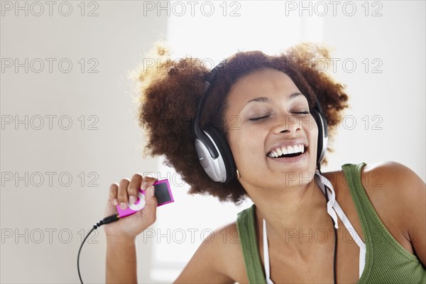 Woman listening to music. Photographer: momentimages