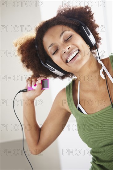 Woman listening to music. Photographer: momentimages