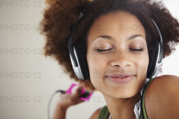 Woman listening to music. Photographer: momentimages