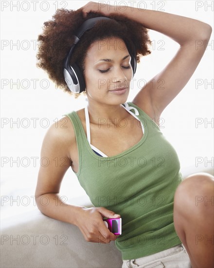 Woman listening to music. Photographer: momentimages