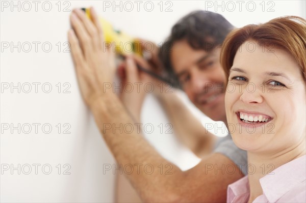 Preparing to hang a picture. Photographer: momentimages