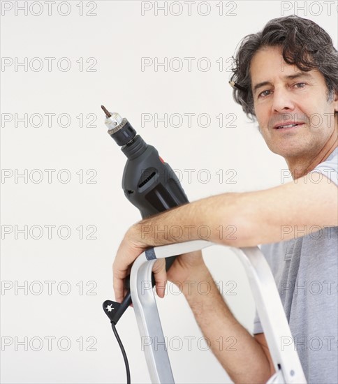 Man holding a drill. Photographer: momentimages