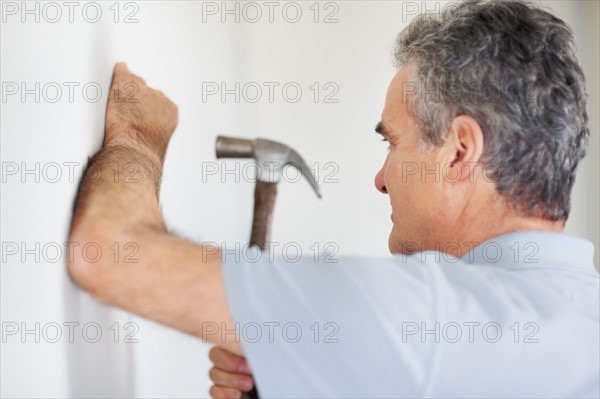 Man using a hammer. Photographer: momentimages