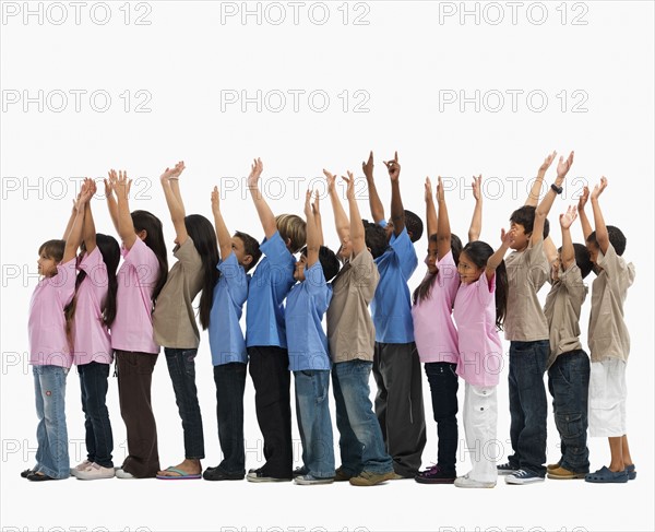 Children raising their arms. Photographer: momentimages