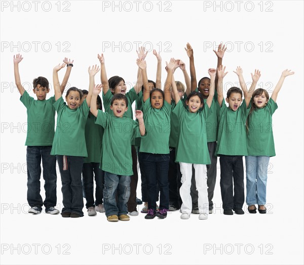 Group of children with their arms raised. Photographer: momentimages