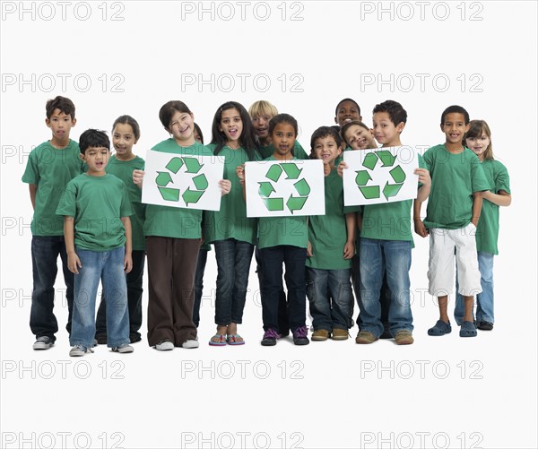 Children holding recycle signs. Photographer: momentimages