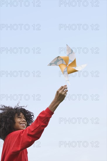 Girl playing with toy windmill. Photographer: Pauline St.Denis