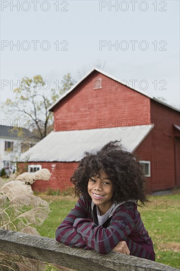 Child leaning on fence. Photographer: Pauline St.Denis