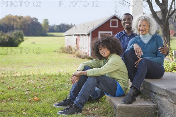 Family sitting on porch. Photographer: Pauline St.Denis