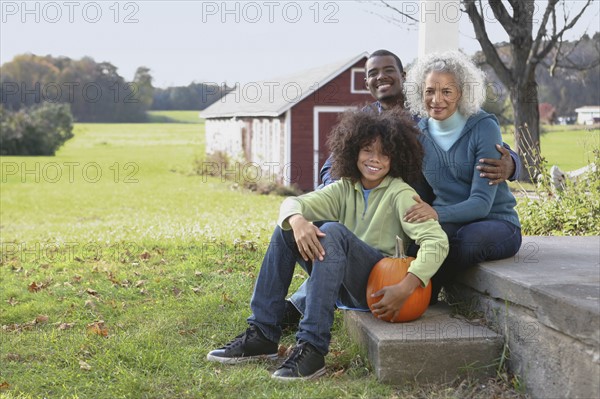 Family sitting on porch. Photographer: Pauline St.Denis