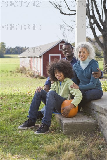 Family sitting on porch. Photographer: Pauline St.Denis